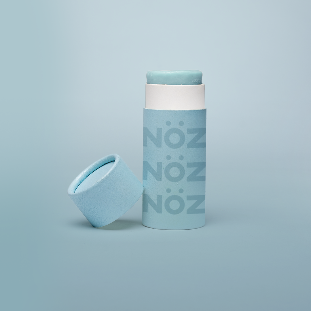 A package of Nöz classic sunscreen in the blue variety in front of a blue background