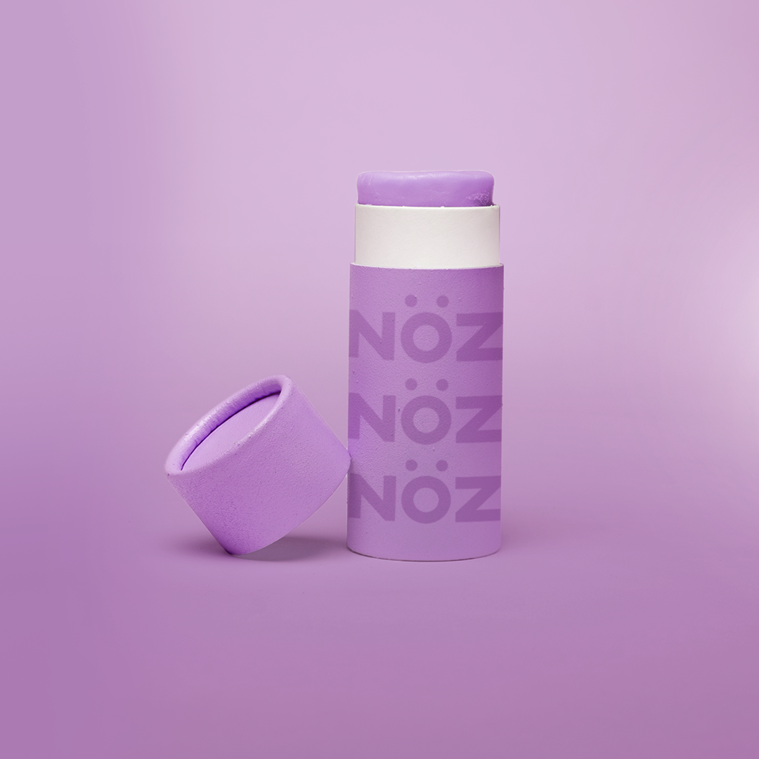 A package of Nöz classic sunscreen in the purple variety in front of a purple background