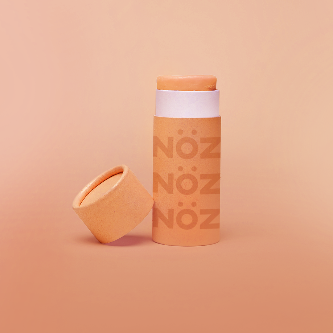 A package of Nöz classic sunscreen in the orange variety in front of an orange background