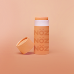 Load image into Gallery viewer, A package of Nöz classic sunscreen in the orange variety in front of an orange background
