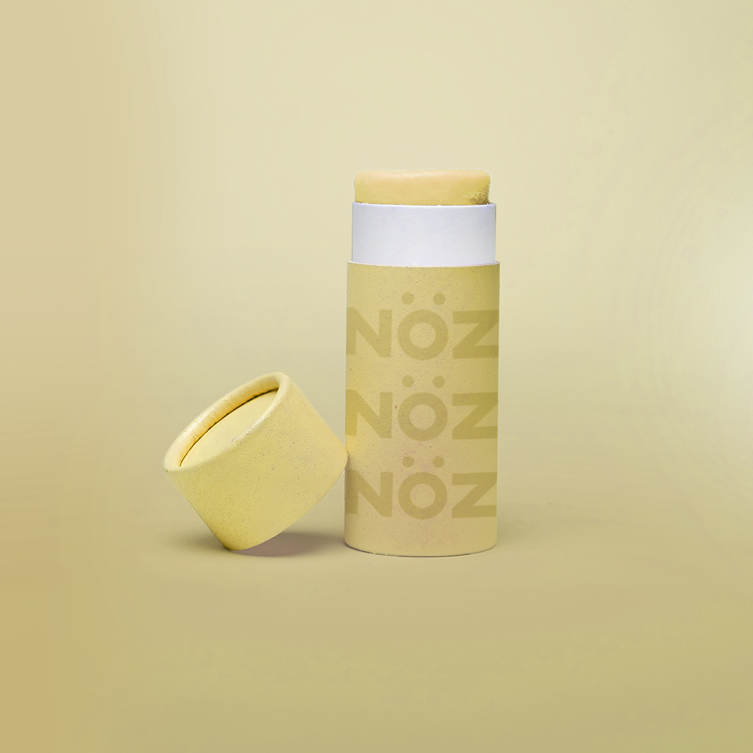 A package of Nöz classic sunscreen in the yellow variety in front of a yellow background